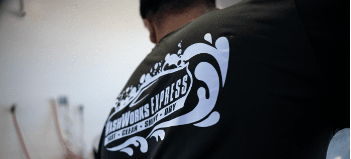 A Washworks Express crew member in branded gear on the wash floor